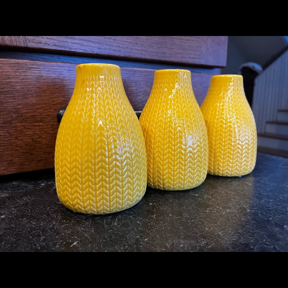 Three yellow decorative vases